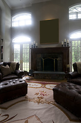 Image showing large living room with leather chairs and fireplace