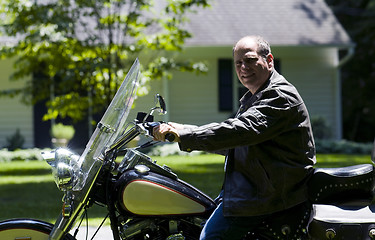 Image showing middle age man on motorcycle with leather jacket