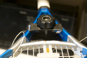 Image showing tennis racquet restring job on machine