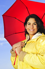 Image showing Beautiful young woman in raincoat with umbrella