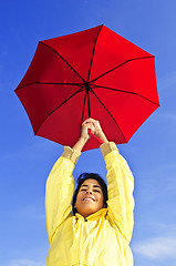 Image showing Beautiful young woman in raincoat with umbrella