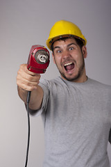 Image showing Freakish worker with protective helmet and drill