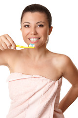 Image showing Smiling woman holding a toothbrush