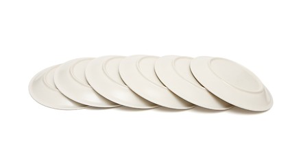 Image showing Stack of plain beige plates tiled upside down isolated