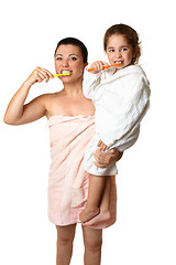 Image showing Mother and daughter brushing their teeth