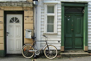 Image showing Bicycle parked between two doors