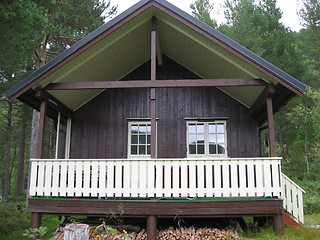 Image showing Cabin with a white fence