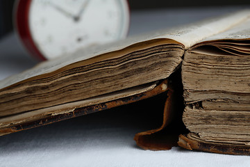 Image showing Old book and analog clock.