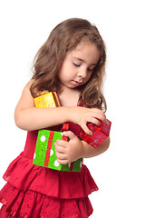 Image showing Girl holding an armful of Christmas presents