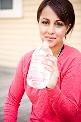 Image showing Sporty woman drinking