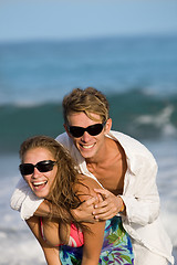 Image showing happy smiling young couple on the beach