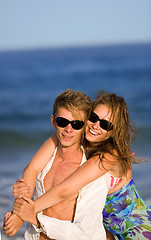 Image showing happy smiling young couple  on the beach