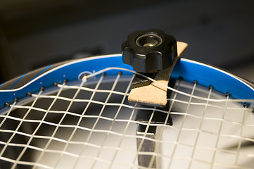 Image showing tennis racquet restring job on machine