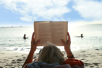 Image showing Reading on beach