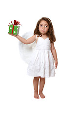 Image showing Little angel girl holding a present