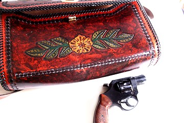 Image showing Leather purse and pistol