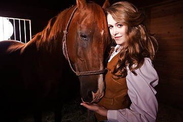 Image showing Beautiful caucasian cowgirl with a horse