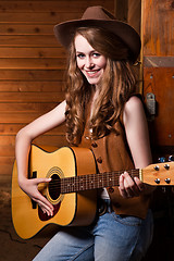 Image showing Beautiful caucasian cowgirl with guitar