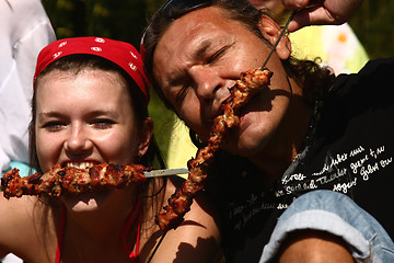 Image showing Man and girl eat a shish kebab