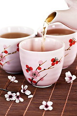 Image showing Pouring green tea