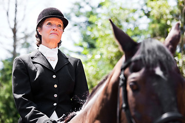 Image showing Horseback riding senior woman