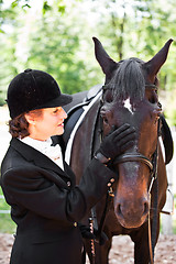 Image showing Horseback riding senior woman