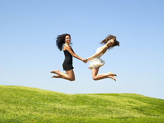 Image showing two jumping woman