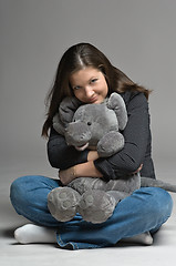 Image showing young woman with big toy mouse
