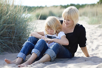 Image showing Mother and daughter at beach.