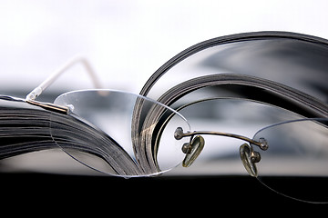 Image showing Close up on the Glasses and the Magazine