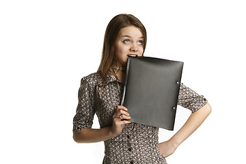 Image showing Girl biting a folder