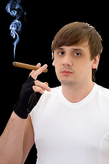 Image showing Young man with cigar. Isolated on black