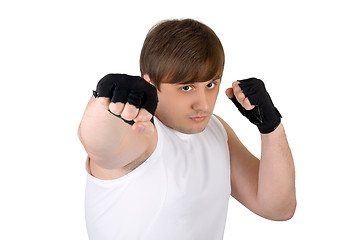 Image showing Young man throwing a punch. Isolated on white