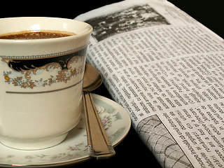 Image showing morning routine with a cup of coffee and newspaper