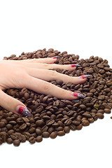 Image showing Female hand and coffee beans