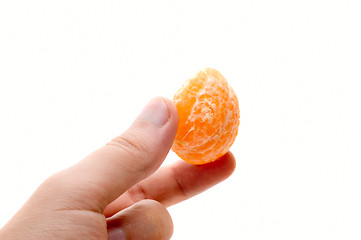 Image showing Hand with mandarin segment