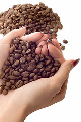 Image showing Female hands and coffee beans
