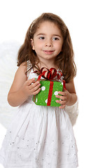 Image showing Little angel girl holding a gift