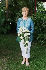 Image showing Mature woman with flowers