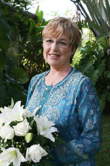 Image showing Mature woman with flowers.