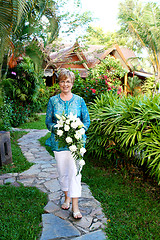 Image showing Mature woman with flowers.