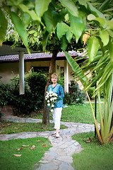 Image showing Mature woman with flowers.