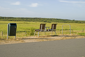 Image showing An empty bench in the dunes looking out to sea