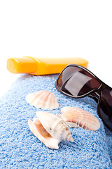 Image showing towel, shells, sunglasses and lotion