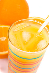 Image showing glass of juice and oranges