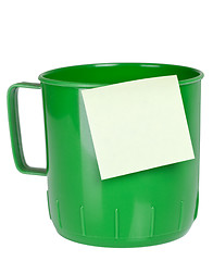 Image showing Green plastic mug with sticky note