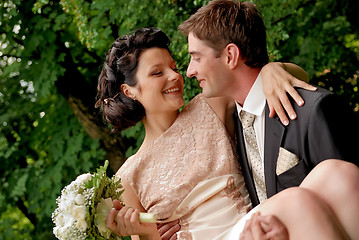 Image showing Happy smiling wedding couple outdoors. 