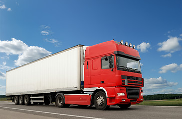 Image showing Red lorry with white trailer over blue sky