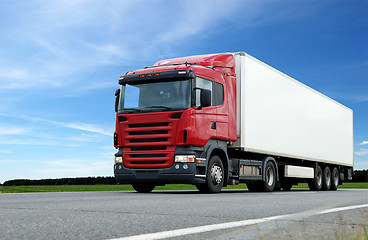 Image showing red lorry with white trailer over blue sky