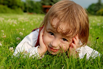 Image showing Close-up little girl on the green grass outdoor